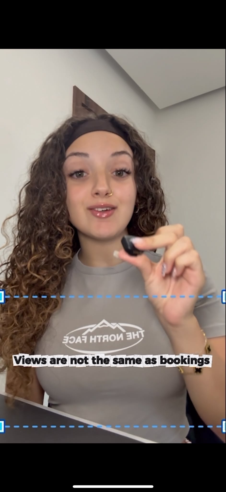 Ellezia Cardona speaking on camera in a social media video about why views are not the same as bookings.